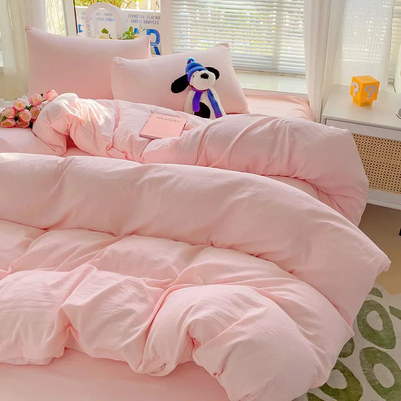 Blush pink cotton bedding set in a bright modern bedroom