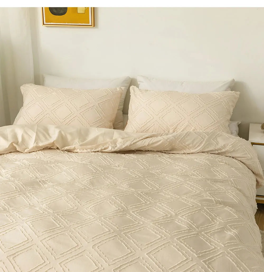 Cream textured geometric bedding set with matching pillowcases styled on a minimalist bed