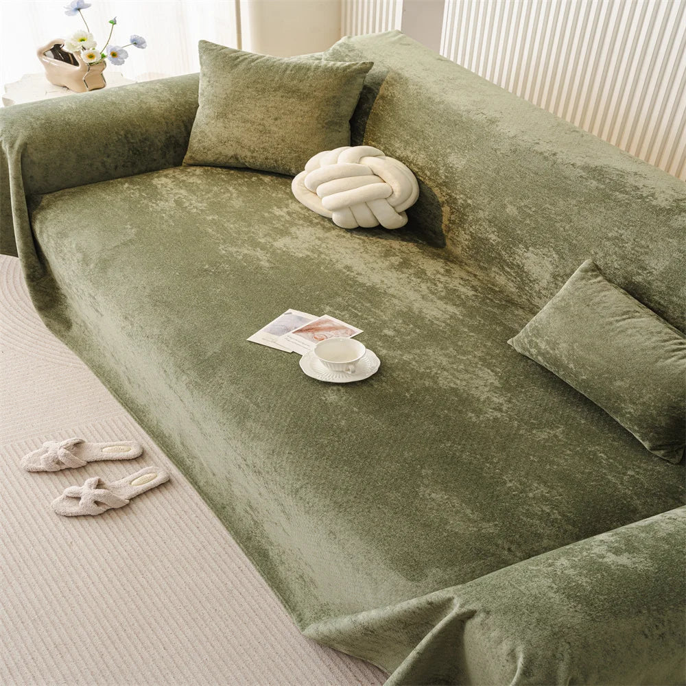 Soft-touch olive sofa throw styled in a minimalist living room